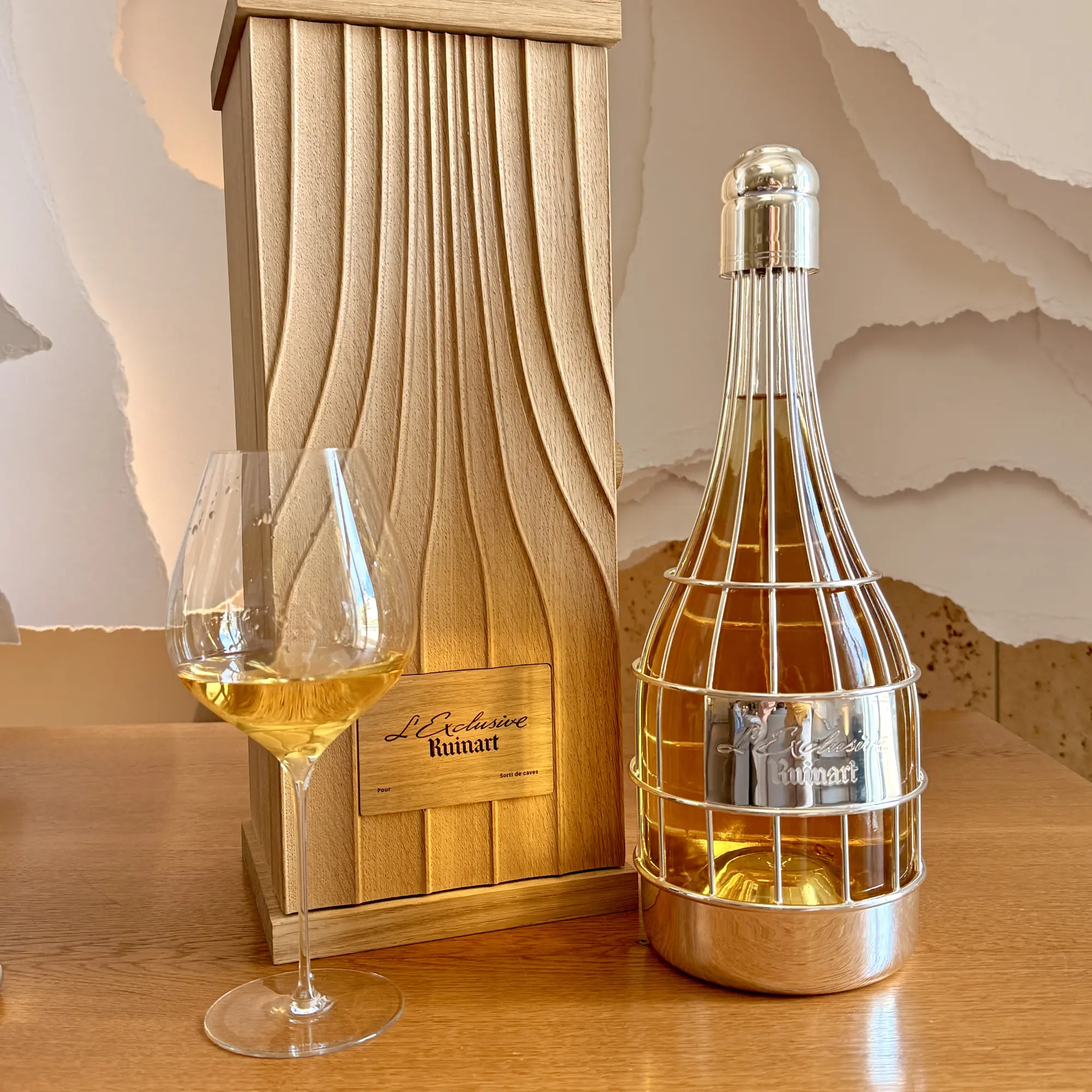 L’Exclusive Ruinart in its silver-coloured bottle holder