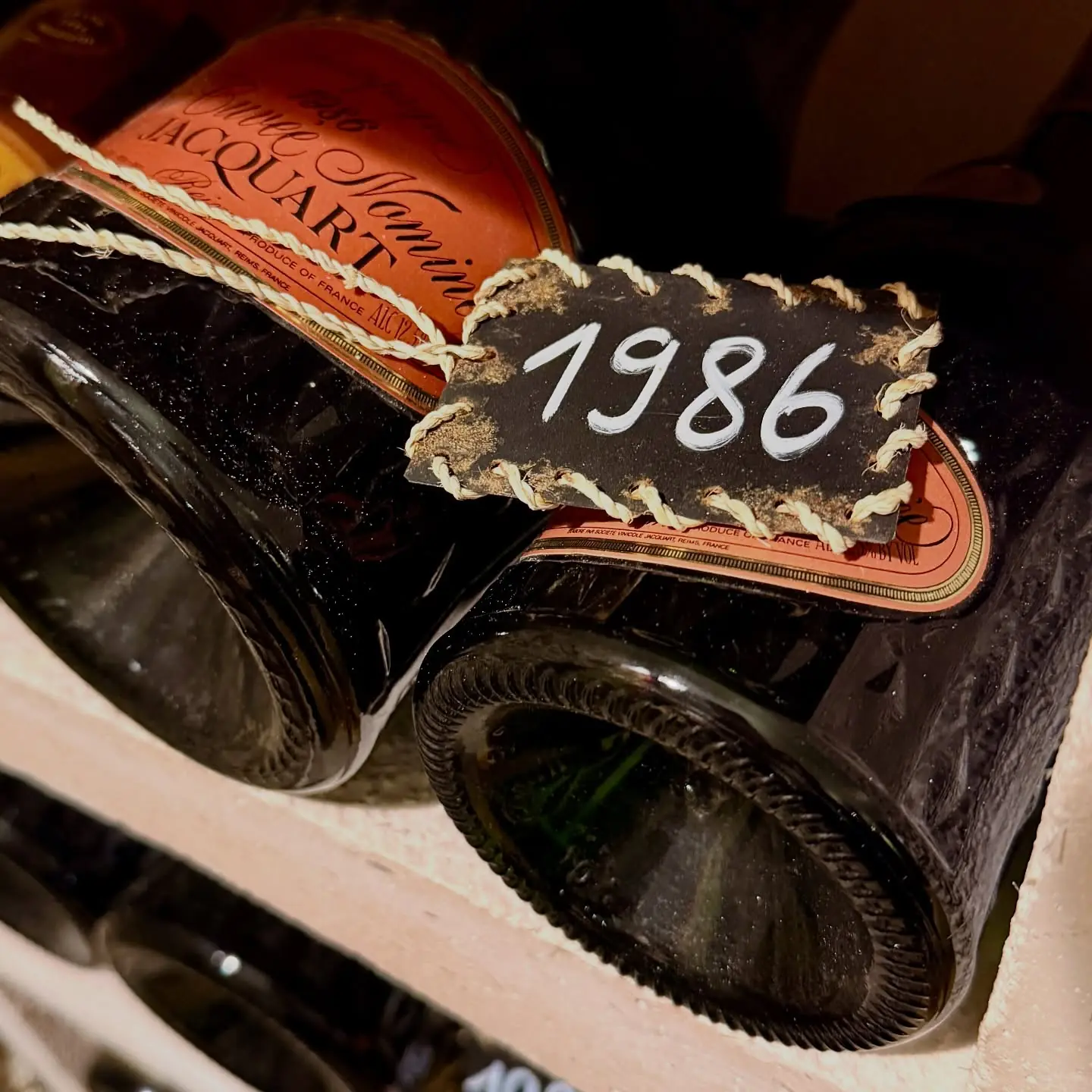 An old Champagne bottle in a Jacquart cellar rack