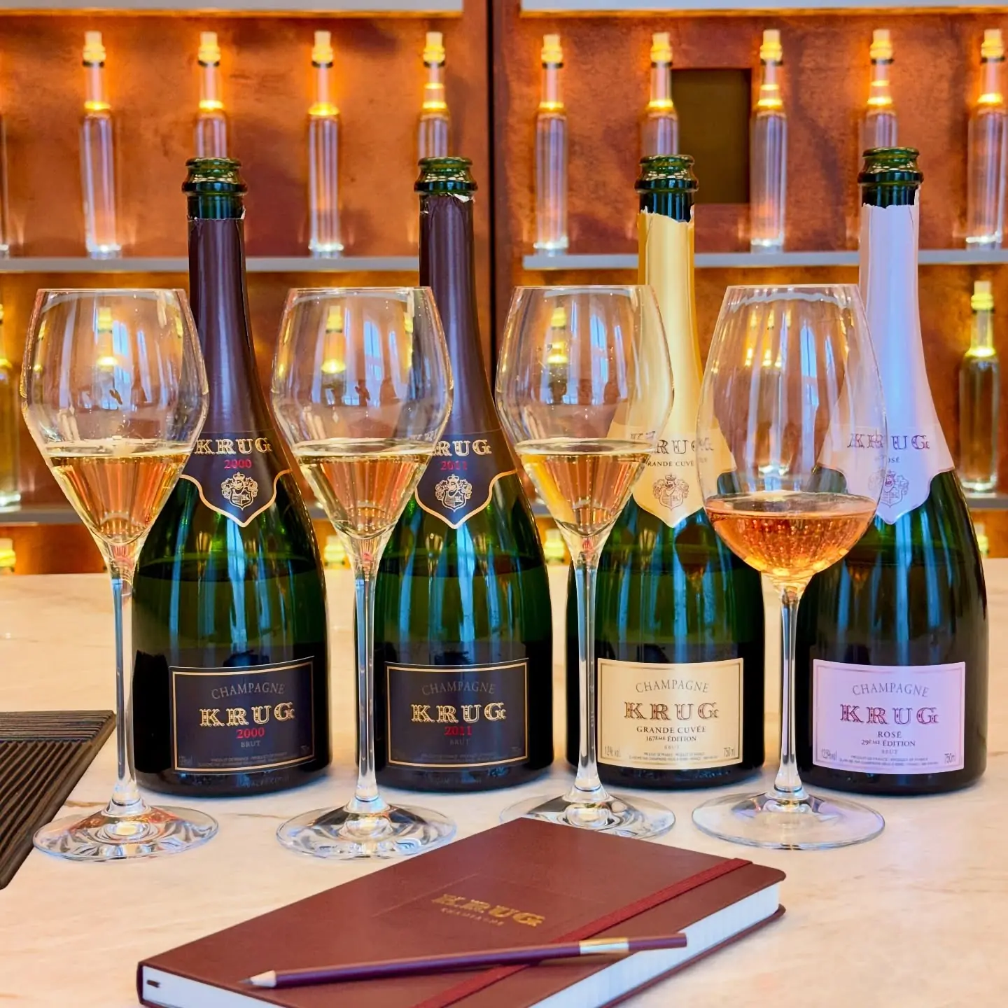 Five Krug bottles and tasting glasses