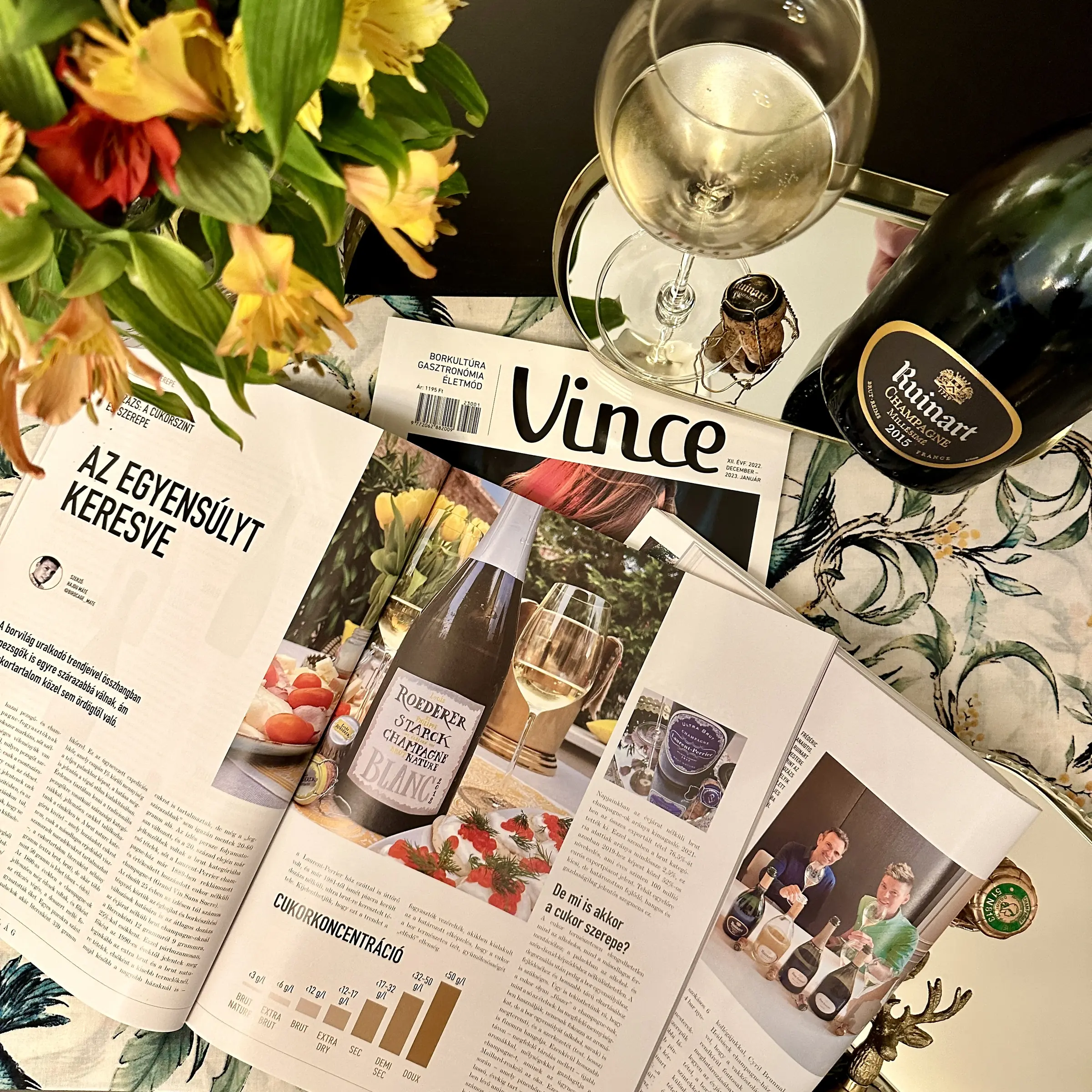 The Vince Magazine article on dosage beside a glass of Champagne